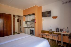 a hotel room with a bed and a kitchen at Turial Old Town Ocean View in Albufeira