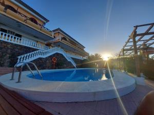 a swimming pool in front of a building at Chalets Rurales Bentayga in Tejeda