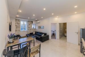 a living room with a couch and a table at Seafront apartments Karlo in Kaštela