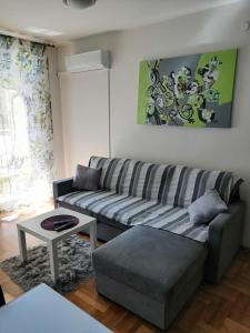 a living room with a couch and a table at Apartment Capital Town-free parking in Zagreb