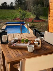 a tray of food on a table next to a pool at LOVE AND BULLES in Le Fleix