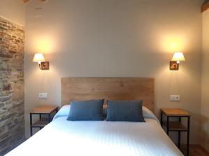 ein Schlafzimmer mit einem Bett mit zwei blauen Kissen in der Unterkunft Casa Guillermo in Barreiros