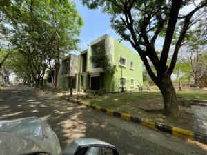 a green building on the side of a street at Samruddhi S1 homestay villa swimming or S3,S20 in Nagpur