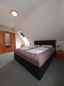 a bedroom with a large bed in a room at Ferienwohnung-Stricker-3-3 in Walkenried