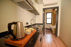 a kitchen with a tea kettle on a counter at Exceptional Flat with Terrace near Hadrian's Gate in Antalya