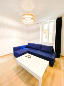- un salon avec un canapé bleu et une table dans l'établissement Superbe T2 calme & confortable - très bien situé!, à Ajaccio