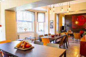 a dining room with two tables and chairs at A l'ombre de la Croisette - Esc'Appart in Dinant