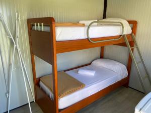 a couple of bunk beds in a room at I Falchi Pellegrini - Bungalow e Tenda in Monzuno