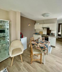 Zimmer mit einem Tisch und Stühlen sowie einer Küche in der Unterkunft Ferienwohnung Min krup unner im Hofhaus in Ahlbeck