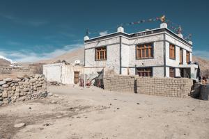 an old stone building in the middle of a desert at RezangLa Homestay in Chushul