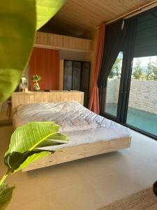 a bedroom with a bed and a large window at PRİME SUİTES in Yalova