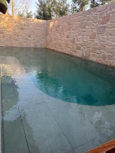 a pool of water next to a brick wall at PRİME SUİTES in Yalova