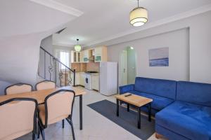 a living room with a blue couch and a table at Gold Lion Hotel in Oludeniz