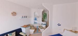 a room with white walls and a staircase with shelves at Piera's Paraiso Seaview in Playa Paraiso