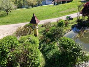 a garden with a bird house in a park at Bauernhof Podorn - Ferienwohnung Panoramablick in Sankt Kanzian