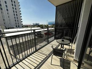 a balcony with a table and chair on a building at Modern Apartment in Racing Paradise: Close to Ferrari World & F1 Track in Abu Dhabi