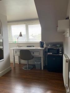 a white desk with a chair in a room at First floor Pad Carterton near Burford in Shilton