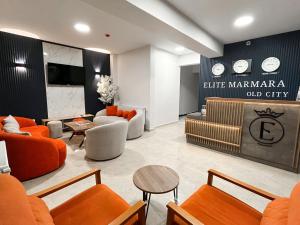 a living room with orange furniture and a lobby at Elite Marmara Old City in Istanbul