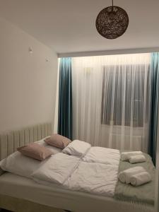 a bed with two pillows on it in a bedroom at Forest Apart I in Warsaw