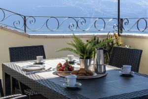 una mesa con un plato de comida en el balcón en Casa Marianna by Garda FeWo, en Tignale