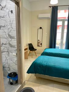 a bedroom with a bed and a glass wall at Hotel Kastoria in Thessaloniki