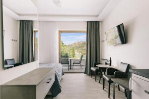 a hospital room with a bed and a table and chairs at Lighthouse Apartments in Stoupa