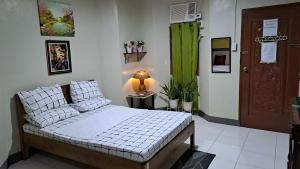 a bedroom with a bed and a green curtain at Dalinda's Homestay in Puerto Princesa City