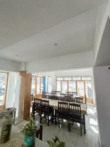 a dining room with a table and chairs at The Stone Palace Turtuk in Nubra
