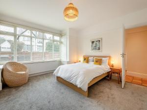 a bedroom with a bed and a large window at Number 3 in Bournemouth