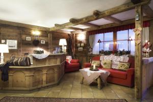 a living room filled with furniture and a fireplace at Chalet Barbara in Arabba