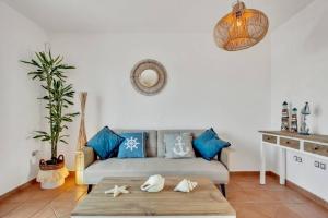 a living room with a couch and a table at Villa Fénix - Oasis in Natural Reserve in Lajares +25 photos