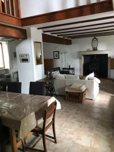 a living room with a couch and a table at Maison L’allee in Lézignac-Durand