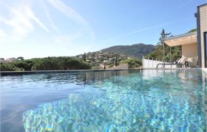a swimming pool in the middle of a house at Beautiful Home In Cavalaire-Sur-Mer in Cavalaire-sur-Mer