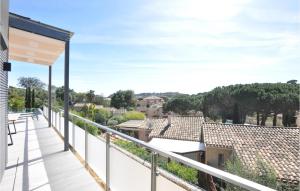 a balcony with a view of the countryside at Beautiful Home In Cavalaire-Sur-Mer in Cavalaire-sur-Mer +18 photos