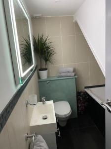 a small bathroom with a toilet and a sink at Trendy 3 Bedroom Home Close To Margate Beaches Bars Resturants 2 Night Min Stay in Kent +12 photos