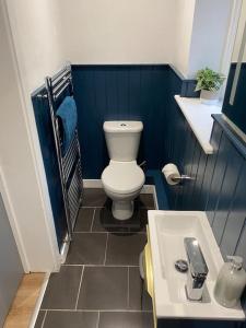 a small bathroom with a toilet and a sink at Trendy 3 Bedroom Home Close To Margate Beaches Bars Resturants 2 Night Min Stay in Kent