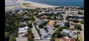 an aerial view of a city with a beach and houses at The Joneses in Plettenberg Bay