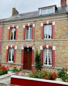 una casa de ladrillo con ventanas rojas y una puerta en Chambre Hote Urban Chic proche Bagnoles SDD privative au Calme, en La Ferté-Macé