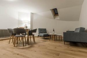 a living room with chairs and a dining room table at Haus Kapell in Schruns