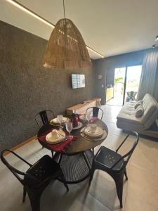 a dining room with a table and chairs and a couch at Villas Manatee - Casa Patacho E002 in Pôrto de Pedras