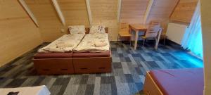 a bedroom with a bed and a table in a room at Penzion Svojanov in Svojanov