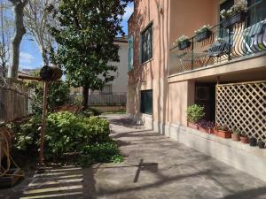 a walkway in front of a building with plants at Casa Venezia in Senigallia