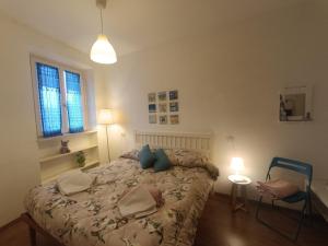 a bedroom with a bed with two pillows on it at Civico1280 Holiday in Camaiore