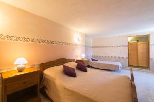 a bedroom with two beds and a mirror at Relais de Saleccia in Casta