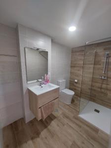 a bathroom with a sink and a shower and a toilet at SDH apartments in Alicante
