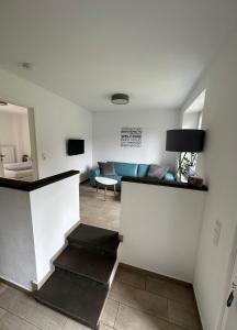 ein Wohnzimmer mit einem blauen Sofa und einem Tisch in der Unterkunft Apartments am Moselufer in Bruttig-Fankel