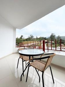 a table and chairs in a room with a balcony at Huascarán Inn in Mancos