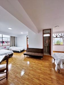 a large room with two beds and a couch at Huascarán Inn in Mancos