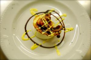 a dessert on a white plate with chocolate sauce at Agriturismo Cavazzone in Regnano