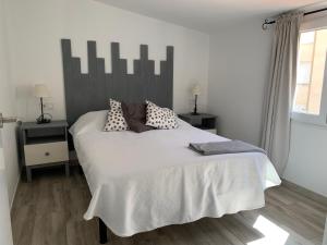 A bed or beds in a room at Atico Casa Mari